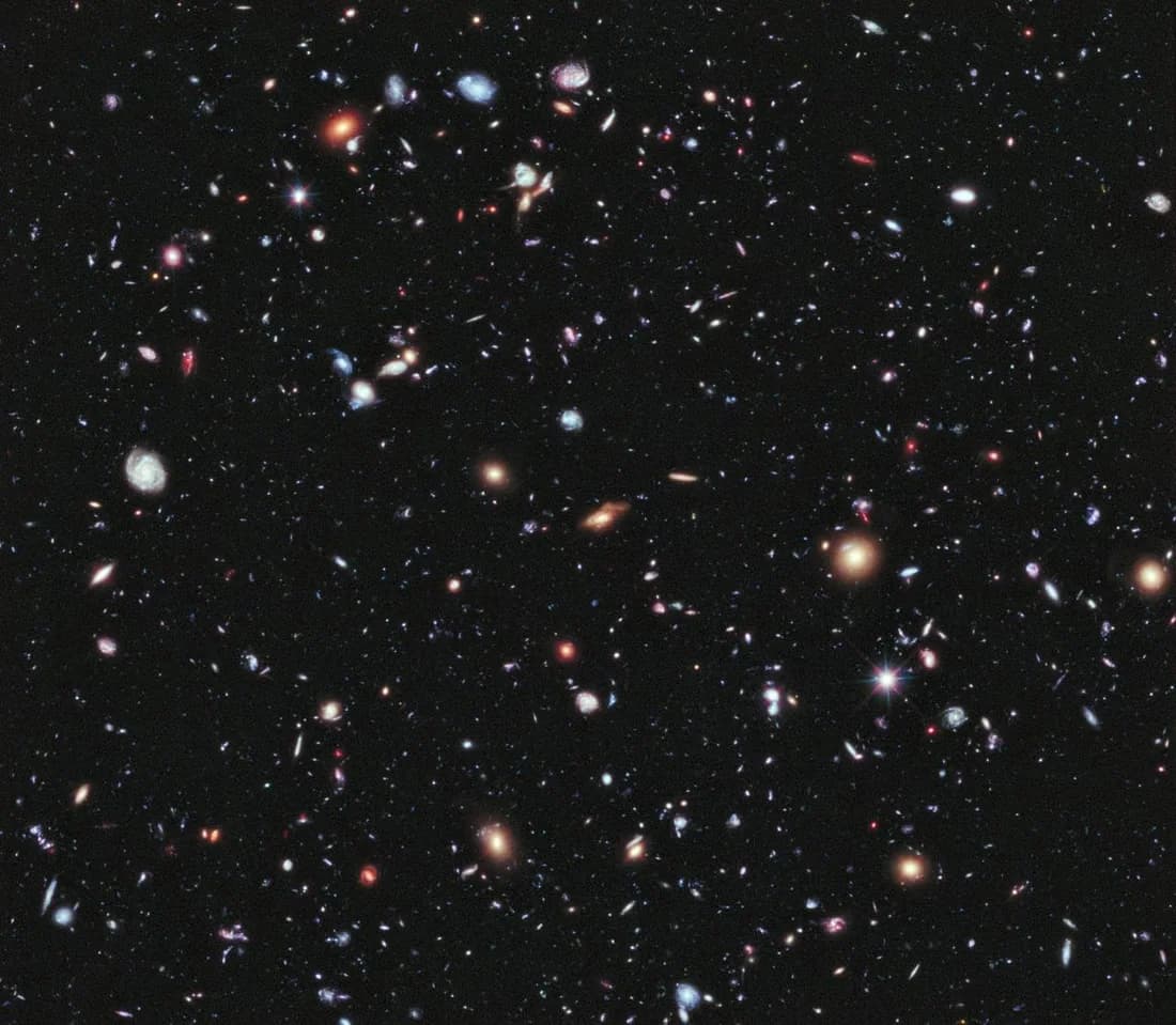 Thousands of distant galaxies against a dark field of space