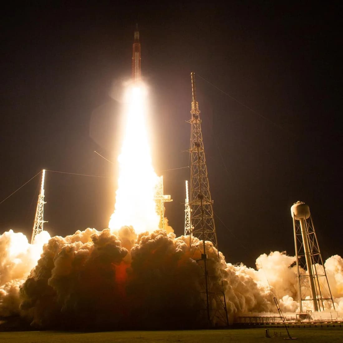 NASA's Space Launch System lifts off with a brilliant plume at night